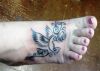tribal bird image tattoo on feet